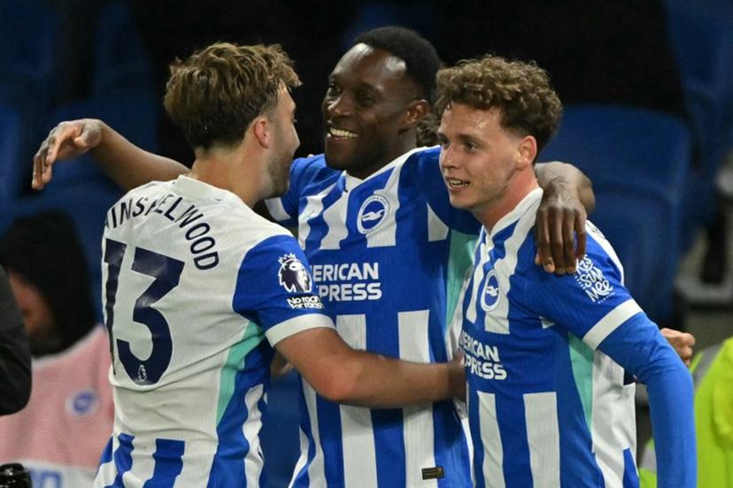 Brighton's English striker #18 Danny Welbeck (C) celebrates with Brighton's English midfielder #13 Jack Hinshelwood (L) and Brighton's Belgian defender #29 Maxim De Cuyper (R) after scoring their third goal during the English Premier League football match between Brighton and Hove Albion and Chelsea at the American Express Community Stadium in Brighton, southern England on April 21, 2026.  Glyn KIRK / AFP