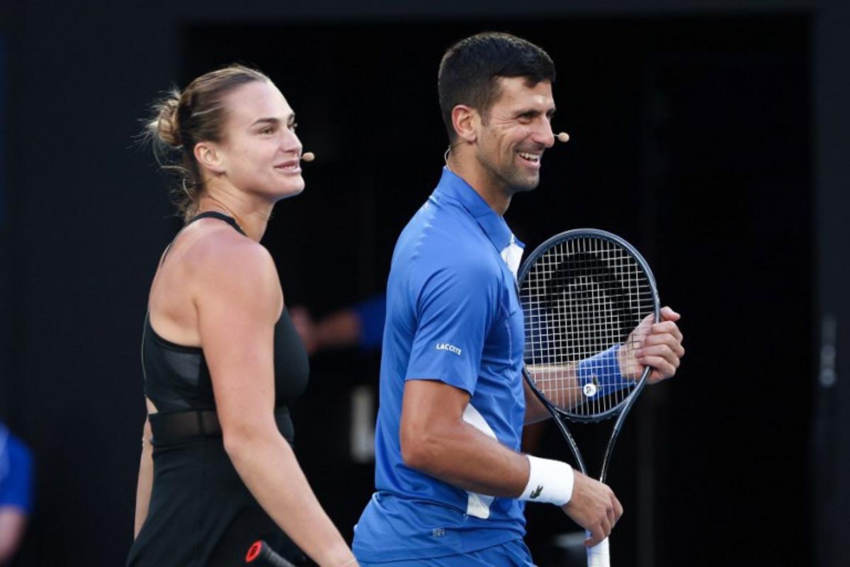 Aryna Sabalenka from Belarus and Serbia's Novak Djokovic play mixed-doubles together during a charity event on Rod Laver Arena in Melbourne on January 11, 2024 ahead of the Australian Open tennis championship starting on January 14.  DAVID GRAY / AFP