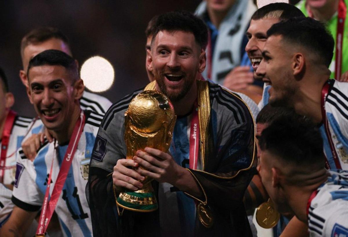 Argentina's captain and forward #10 Lionel Messi lifts the FIFA World Cup Trophy during the trophy ceremony after Argentina won the Qatar 2022 World Cup final football match between Argentina and France at Lusail Stadium in Lusail, north of Doha on December 18, 2022.  Adrian DENNIS / AFP
