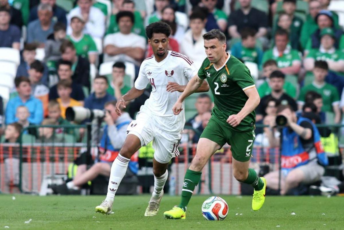 Republic of Ireland's defender Seamus Coleman is put under pressure by Qatar's Defender #04 Issa Laye during the international friendly football match between the Republic of Ireland and Qatar, at the Aviva Stadium in Dublin, Ireland on May 28, 2026.  Paul Faith / AFP