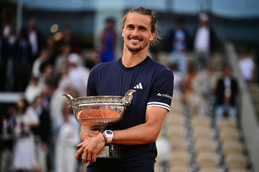 Germany's Alexander Zverev poses with "La Coupe des Mousquetaires" trophy after winning the French Open tennis tournament men's singles final match against Italy's Flavio Cobolli on day 15 of the French Open tennis tournament on Court Philippe-Chatrier at the Roland-Garros Complex in Paris on June 7, 2026.  JULIEN DE ROSA / AFP