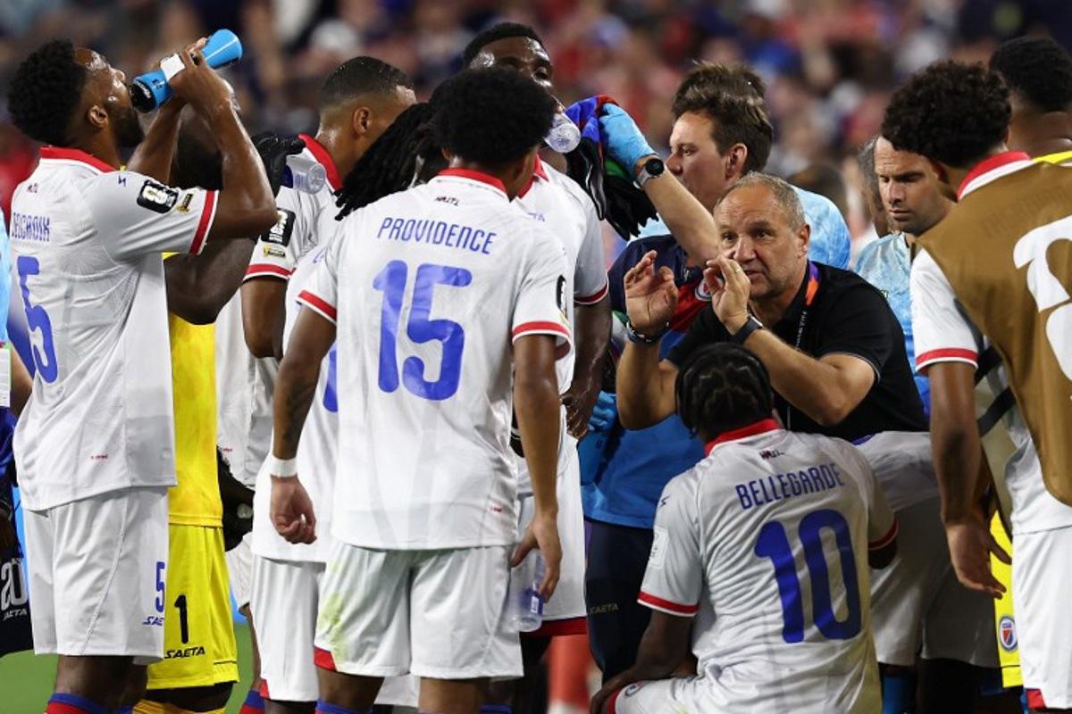 Haiti's French head coach Sebastien Migne talks to his players during the hydration break during the 2026 World Cup Group C football match between Haiti and Scotland at the Boston Stadium in Foxborough on June 13, 2026.  FRANCK FIFE / AFP