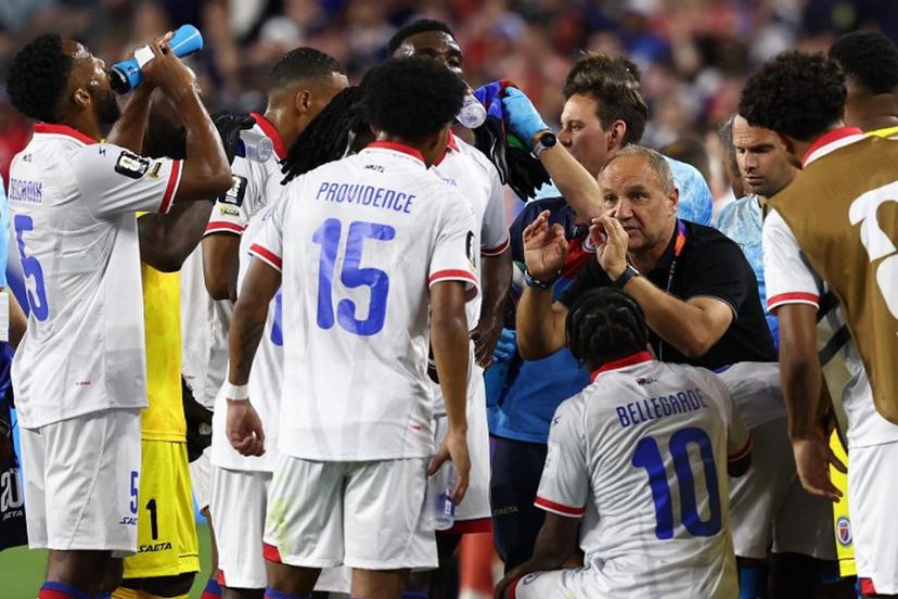 Haiti's French head coach Sebastien Migne talks to his players during the hydration break during the 2026 World Cup Group C football match between Haiti and Scotland at the Boston Stadium in Foxborough on June 13, 2026.  FRANCK FIFE / AFP