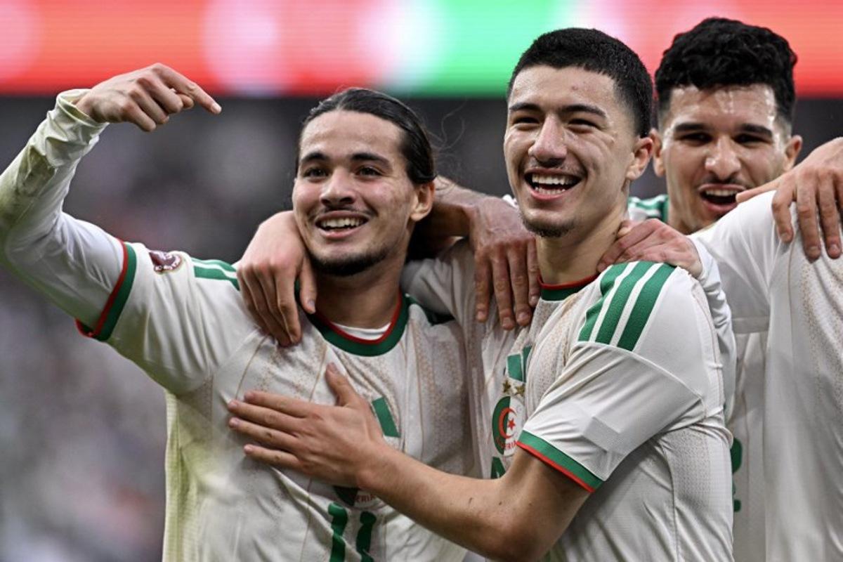 Algeria's midfielder #22 Ibrahim Maza (C) celebrates scoring his team's third goal with Algeria's forward #11 Anis Hadj Moussa during the Africa Cup of Nations (CAN) Group E football match between Equatorial Guinea and Algeria at Moulay Hassan Stadium in Rabat on December 31, 2025.   Gabriel BOUYS / AFP