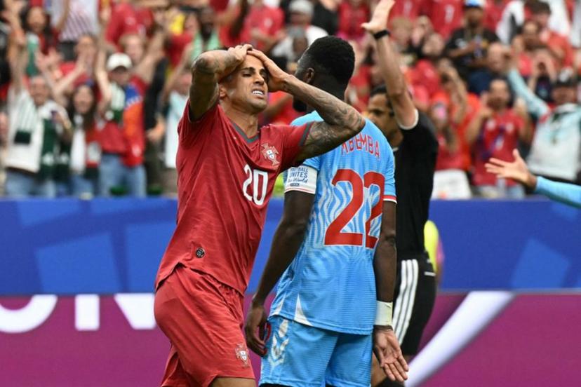 Portugal's defender #20 Joao Cancelo (L) reacts after missing a goal opportunity  during the 2026 World Cup Group K football match between Portugal and the Democratic Republic of Congo at the Houston Stadium in Houston on June 17, 2026.   RONALDO SCHEMIDT / AFP