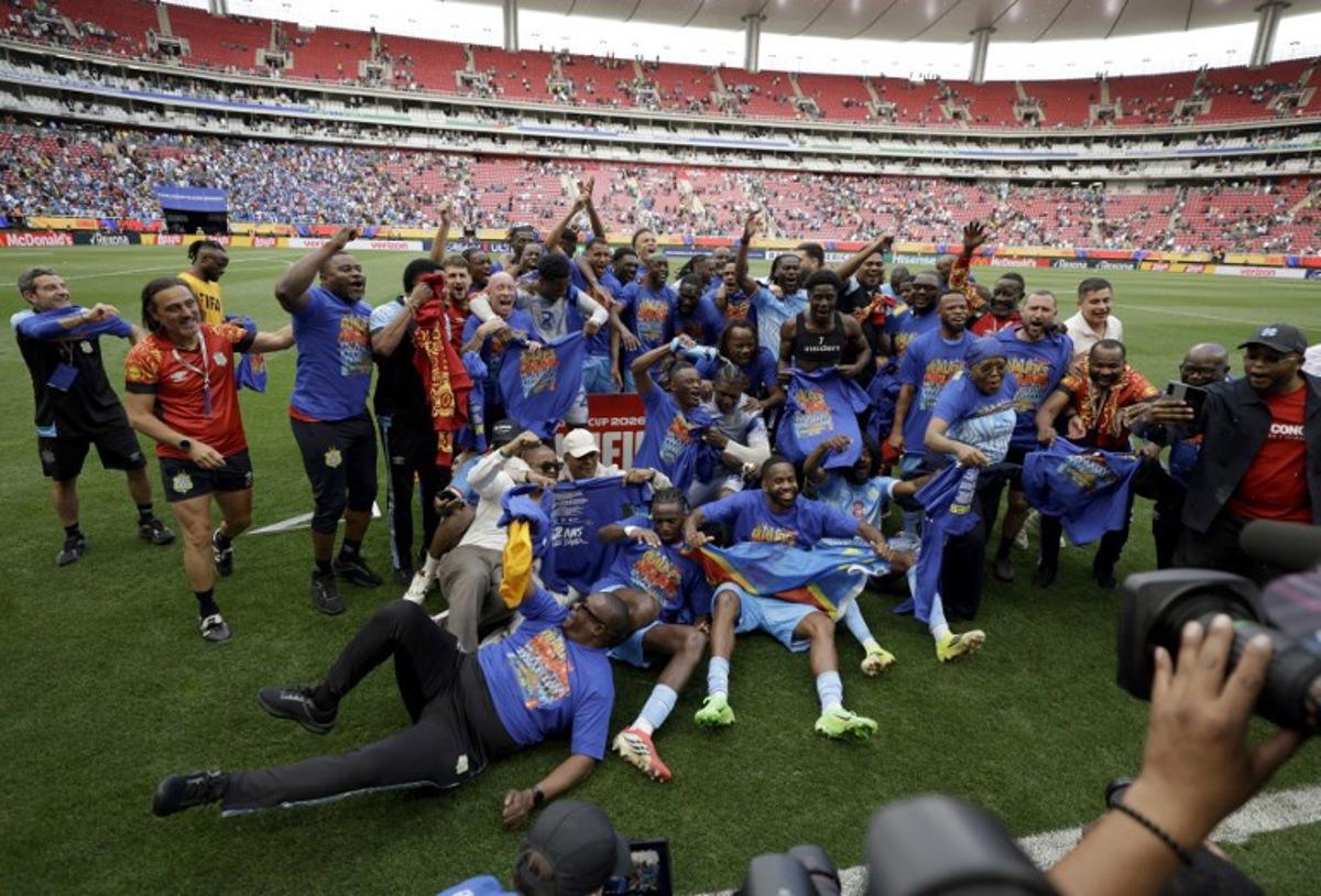 DR Congo players and coaching staff celebrate after winning the match and qualifying for the World Cup during the 2026 FIFA World Cup qualifiers final playoff football match between the Democratic Republic of the Congo and Jamaica at the Akron Stadium in Zapopan, Jalisco state, Mexico, on March 31, 2026.  Ulises Ruiz / AFP