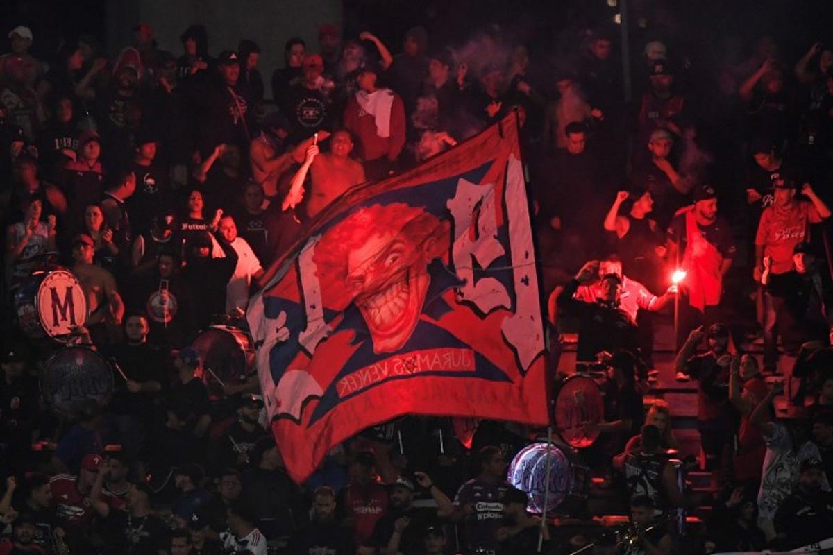 Medellin fans set off flares during the Copa Libertadores group stage football match between Colombia's Independiente Medellin and Brazil's Flamengo at the Atanasio Girardot stadium in Medellin, Antioquia department, Colombia on May 7, 2026. The match between Colombia's Independiente Medellin and Flamengo, the reigning Copa Libertadores champions, was cancelled following incidents triggered by protests from the home team's fans in the stands, Conmebol said on May 7. Jaime SALDARRIAGA / AFP