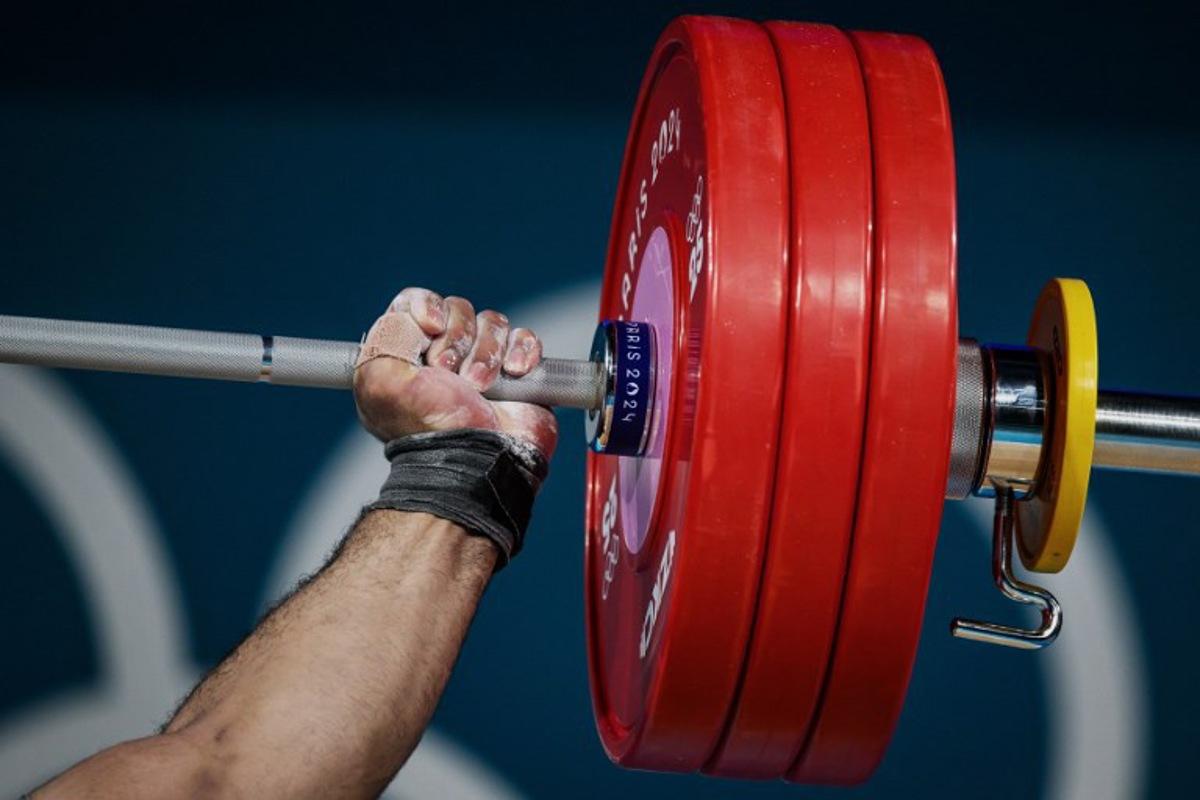 Estonia's Mart Seim competes in the men's +102kg weightlifting event during the Paris 2024 Olympic Games at the South Paris Arena in Paris, on August 10, 2024.   JEFF PACHOUD / AFP