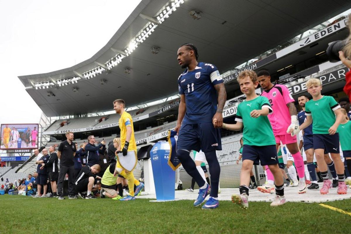 Cape Verde's Garry Rodrigues (R) leads his team out during the international friendly football match between Cape Verde and Finland at Eden Park in Auckland on March 30, 2026.  Michael Bradley / AFP