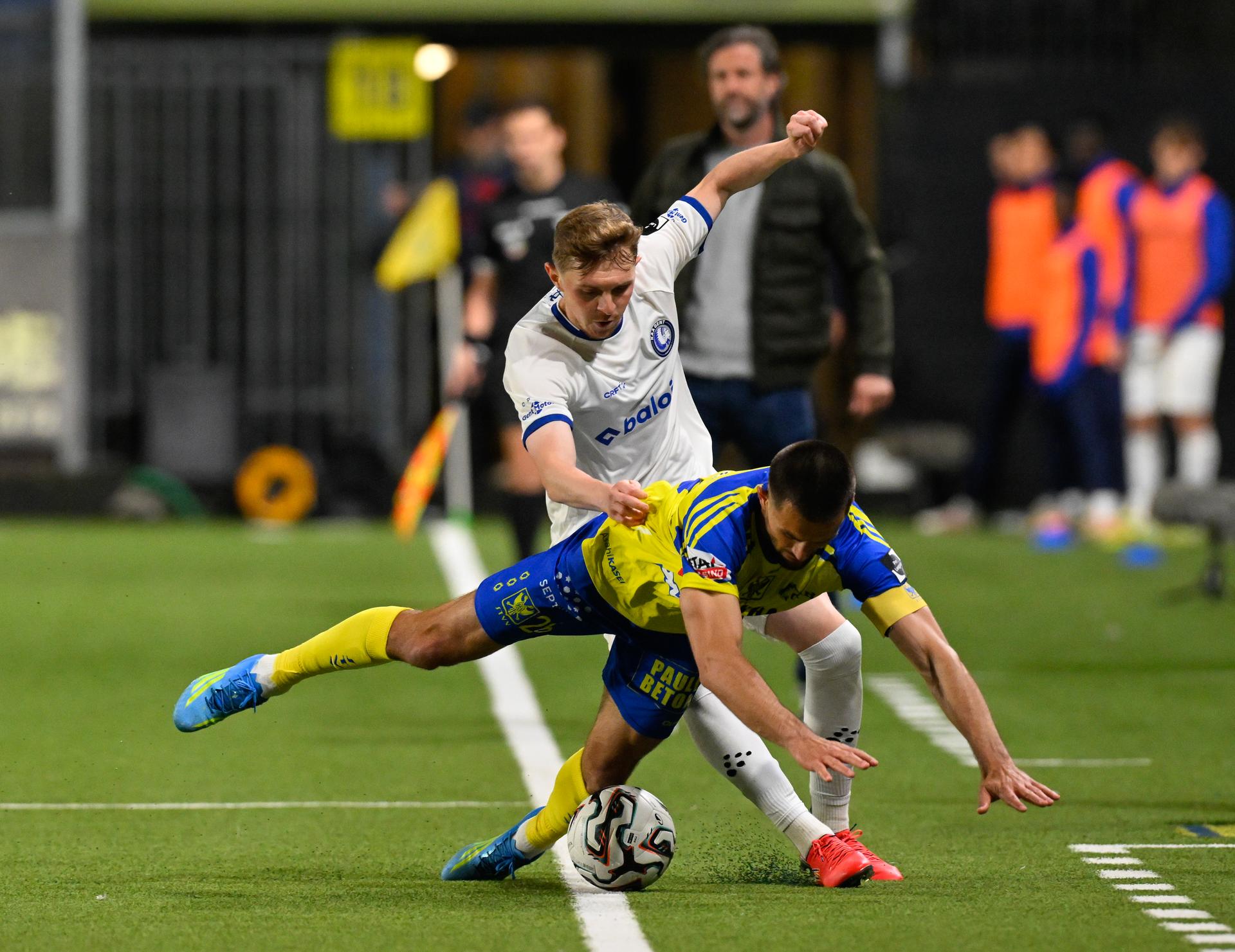 Gent's Max Dean and STVV's Visar Musliu fight for the ball during a soccer match between Sint-Truiden VV and KAA Gent, Saturday 16 May 2026 in Sint-Truiden, on the eight day of the Champion's Play-offs of the 2025-2026 'Jupiler Pro League' first division of the Belgian championship. BELGA PHOTO JOHN THYS