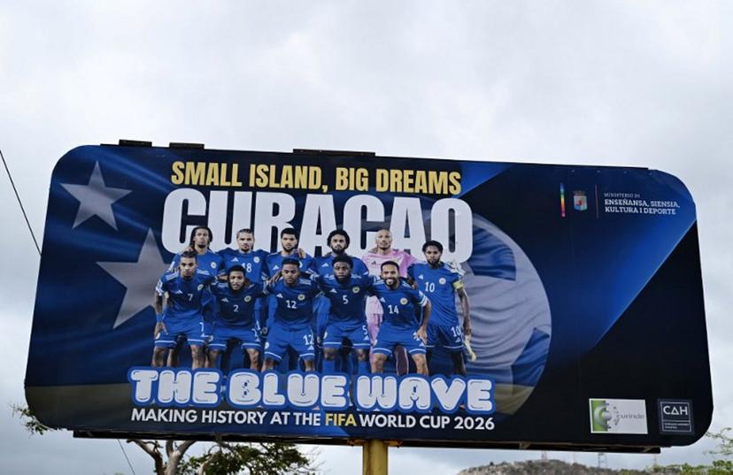 View of a banner depicting the Curacao national football team in Willemstad, in the Dutch Caribbean, on April 11, 2026. Small island, big dreams. The poster of Curacao's national football team hangs at the entrance of Marchena, a working-class neighborhood of Willemstad, the capital of the smallest territory ever to qualify for a World Cup. Raul ARBOLEDA / AFP