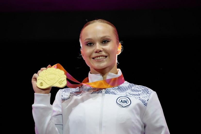 First-placed Individual Neutral Athlete (AIN) Angelina Melnikova (C) with the gold medal poses during the victory ceremony for the women's vault final at the 53rd FIG Artistic Gymnastics World Championships in Jakarta on October 24, 2025.   Yasuyoshi CHIBA / AFP