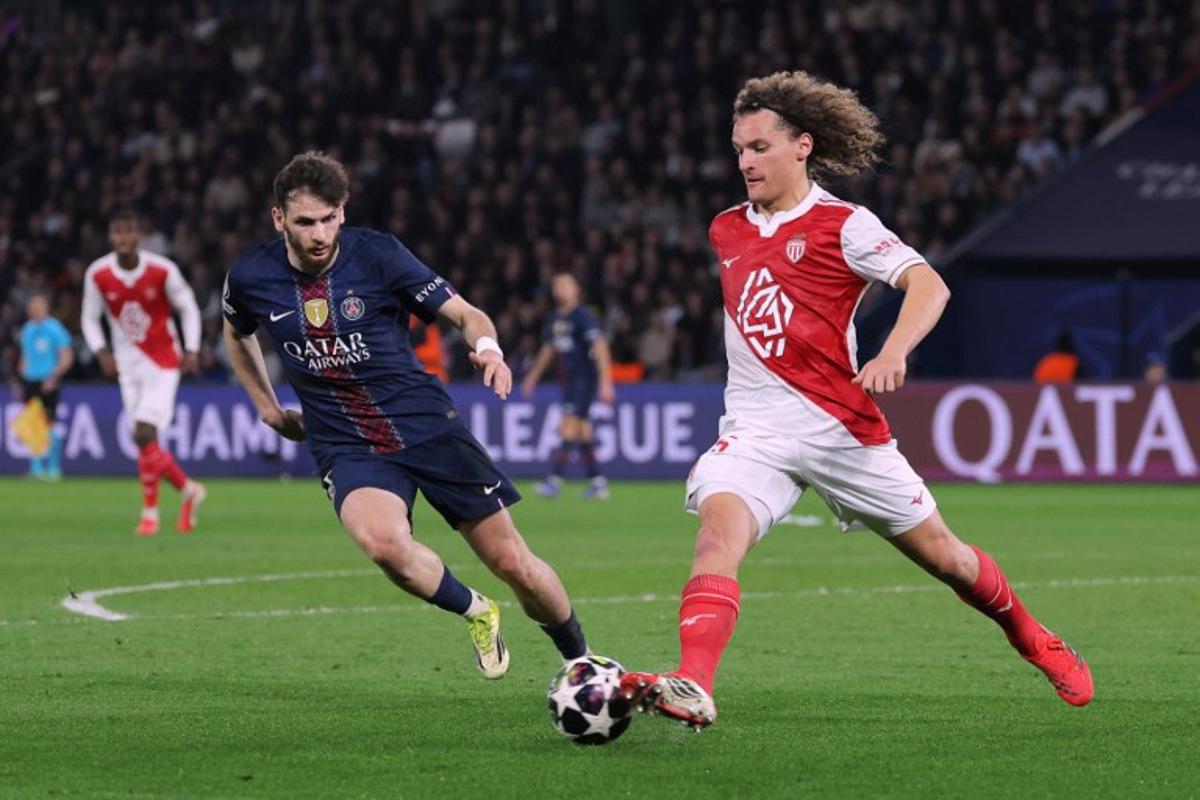 Monaco's Belgian defender #25 Wout Faes (R) controls the ball in front of Paris Saint-Germain's Georgian forward #07 Khvicha Kvaratskhelia (L) during the UEFA Champions League play-off second leg football match between Paris Saint-Germain (PSG) and AS Monaco at the Parc des Princes stadium in Paris on February 25, 2026.  Thomas SAMSON / AFP