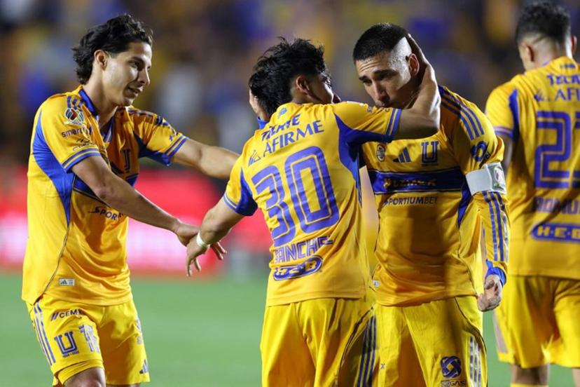 Tigres' forward #30 Diego Sanchez celebrates with Uruguayan midfielder #08 Fernando Gorriaran (R) and midfielder #16 Diego Lainez after scoring his team's third goal during the Mexican League Clausura Tournament quarterfinal first leg football match between Tigres and Guadalajara at the Universitario stadium in Monterrey, Nuevo Leon state, Mexico on May 2, 2026.  Julio Cesar AGUILAR / AFP