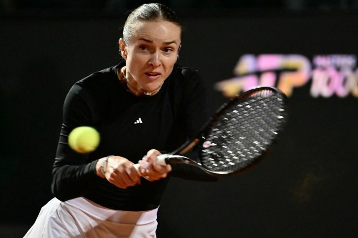 Ukraine's Elina Svitolina hits a return to Poland's Iga Swiatek during the WTA Rome Open tennis tournament at Foro Italico in Rome on May 14, 2026.   Filippo MONTEFORTE / AFP
