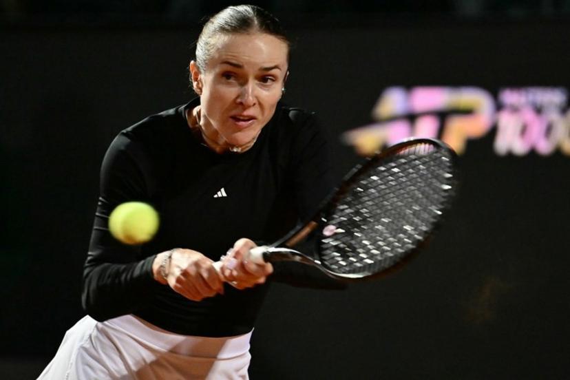 Ukraine's Elina Svitolina hits a return to Poland's Iga Swiatek during the WTA Rome Open tennis tournament at Foro Italico in Rome on May 14, 2026.   Filippo MONTEFORTE / AFP