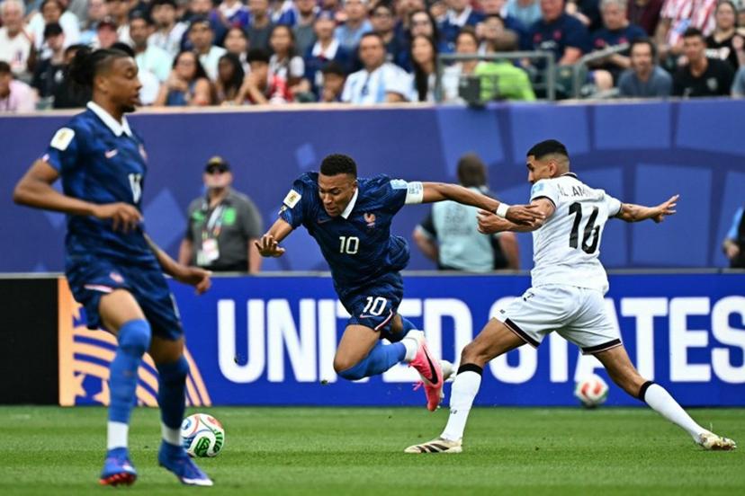 France's forward #10 Kylian Mbappe eludes Iraq's midfielder #16 Amir Al Ammari during the 2026 World Cup Group I football match between France and Iraq at the Philadelphia Stadium in Philadelphia on June 22, 2026.   Jewel SAMAD / AFP