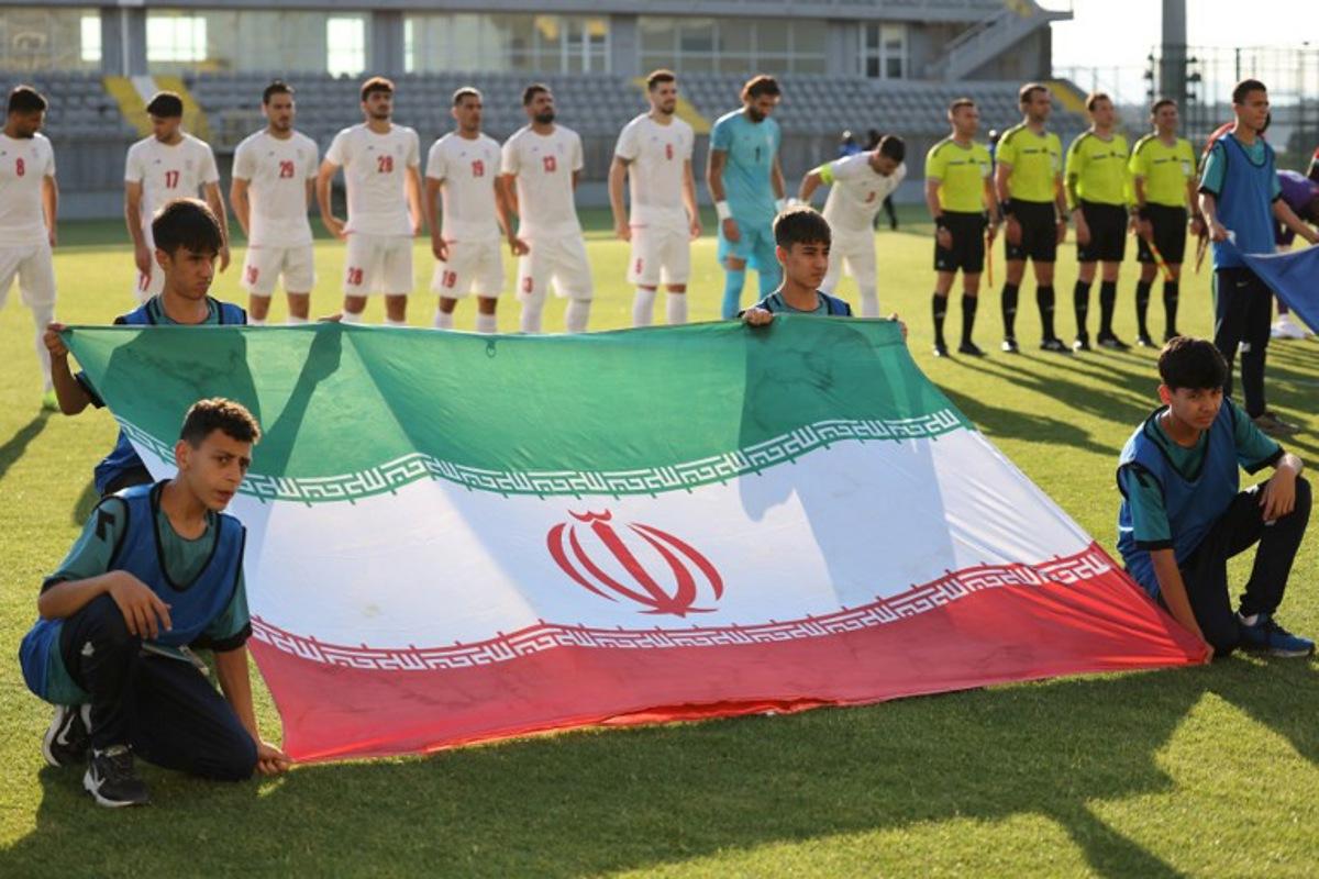 Iran's players stand behind the flag of Iran for photographers before the start of an international  friendly football match between Iran and Gambia, in Antalya, southern Turkey, on May 29, 2026, as part of the team's preparation for the upcoming football World Cup.  Oner SAN / AFP