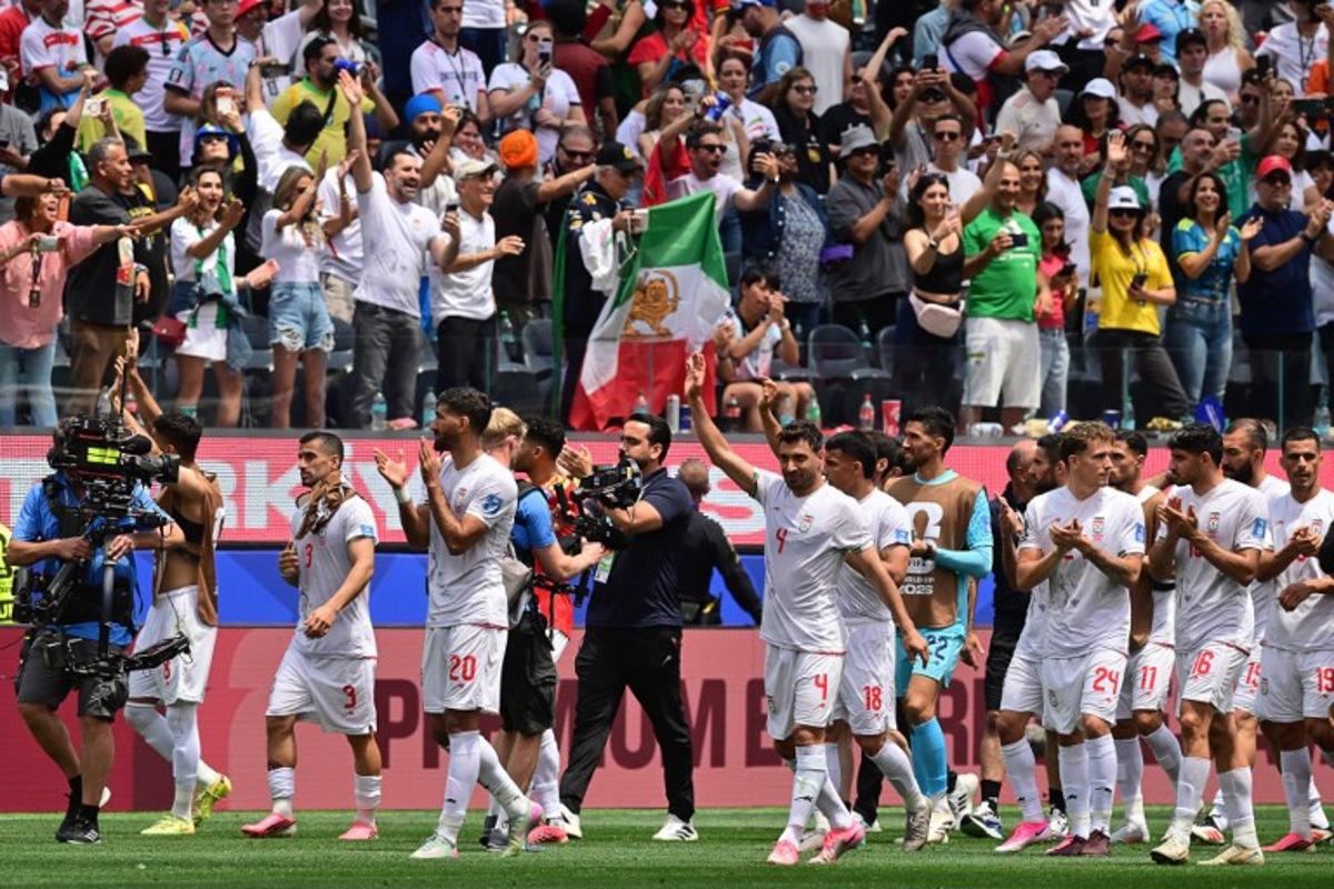 Iran's players celebrate at the end of the 2026 World Cup Group G football match between Belgium and Iran at the Los Angeles Stadium in Inglewood on June 21, 2026.   Frederic J. Brown / AFP