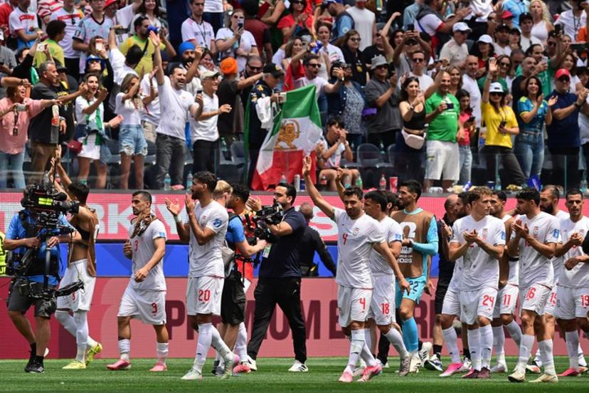 Iran's players celebrate at the end of the 2026 World Cup Group G football match between Belgium and Iran at the Los Angeles Stadium in Inglewood on June 21, 2026.   Frederic J. Brown / AFP