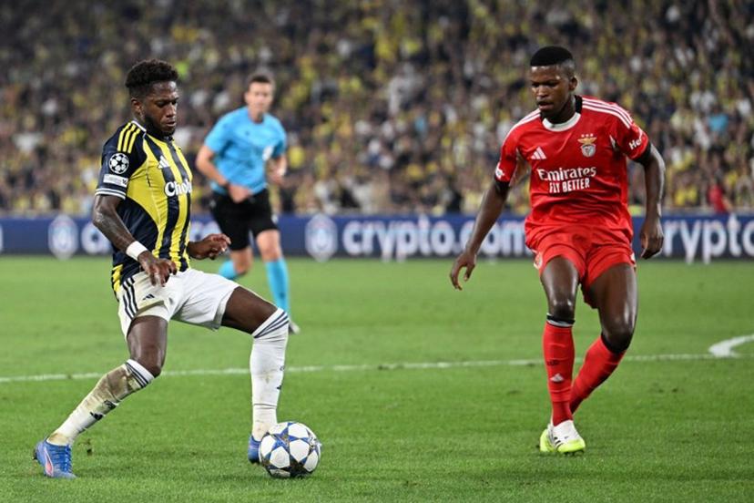 Fenerbahce's Brazilian midfielder #7 Fred (L) kicks the ball next to Benfica's Portuguese midfielder #61 Florentino (R) during the UEFA Champions League play off first leg football match between Fenerbahce (TUR) and Benfica (POR) at the Fenerbahce Sukru Saracoglu Sport Complex in Istanbul on August 20, 2025.  Ozan KOSE / AFP