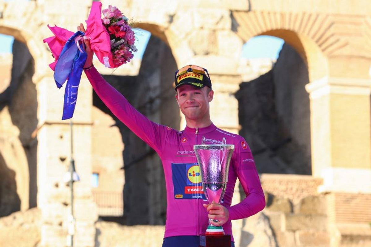 Team Lidl-Trek's Italian rider Jonathan Milan celebrates his best sprinter's purple (cyclamen) jersey on the podium in front of the Colosseum after the 21st and last stage of the 107th Giro d'Italia cycling race, 125km from Rome to Rome on May 26, 2024.  Luca Bettini / AFP