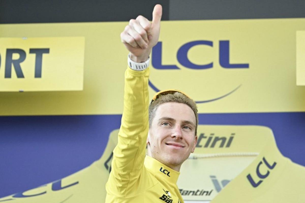 UAE Team Emirates - XRG's Slovenian rider Tadej Pogacar celebrates on the podium with the overall leader's yellow jersey after the 13th stage of the 113th edition of the Tour de France cycling race, 205,8 km between Dole and Belfort in eastern France, on July 17, 2026.  Loic VENANCE / AFP