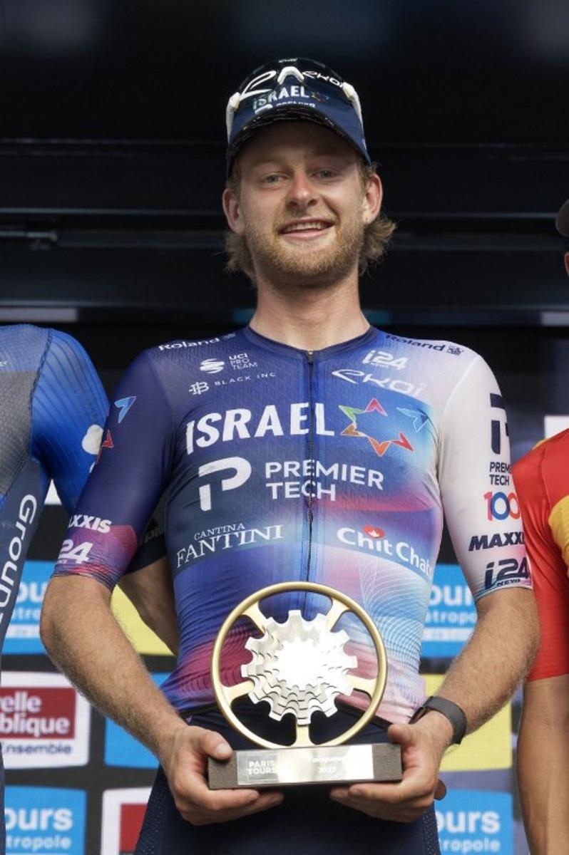 First-placed Israel Premier Tech's US rider Riley Sheehan celebrates on the podium after winning the 117th edition of the 213,9 km Paris-Tours one day cycling race, in Tours, central France on October 8, 2023.   GUILLAUME SOUVANT / AFP