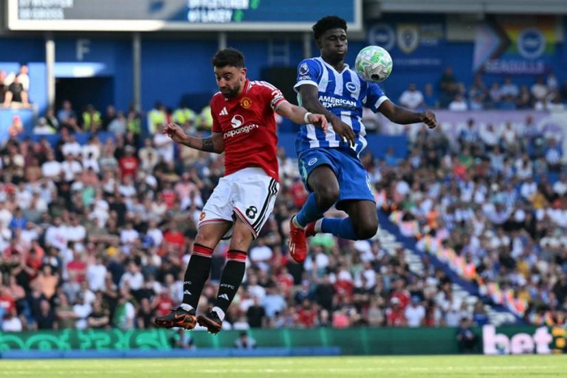 Manchester United's Portuguese midfielder #08 Bruno Fernandes (L) vies with Brighton's Cameroonian midfielder #17 Carlos Baleba during the English Premier League football match between Brighton and Hove Albion and Manchester United at the American Express Community Stadium in Brighton, southern England on May 24, 2026.  Glyn KIRK / AFP