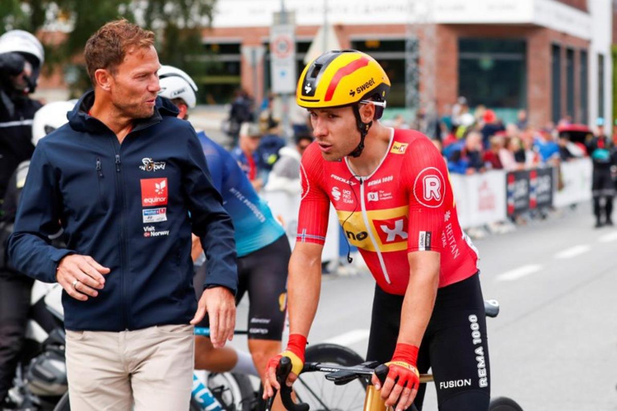 Uno-X Pro Cycling Team's Norwegian rider Fredrik Dversnes (R) is welcomed by Uno-X Mobility's CEO Thor Hushovd (L) after winning the fourth and final stage of the Arctic Cyling Race 2025 in Tromso, Norway, on August 10, 2025.  Rune Stoltz Bertinussen / NTB / AFP