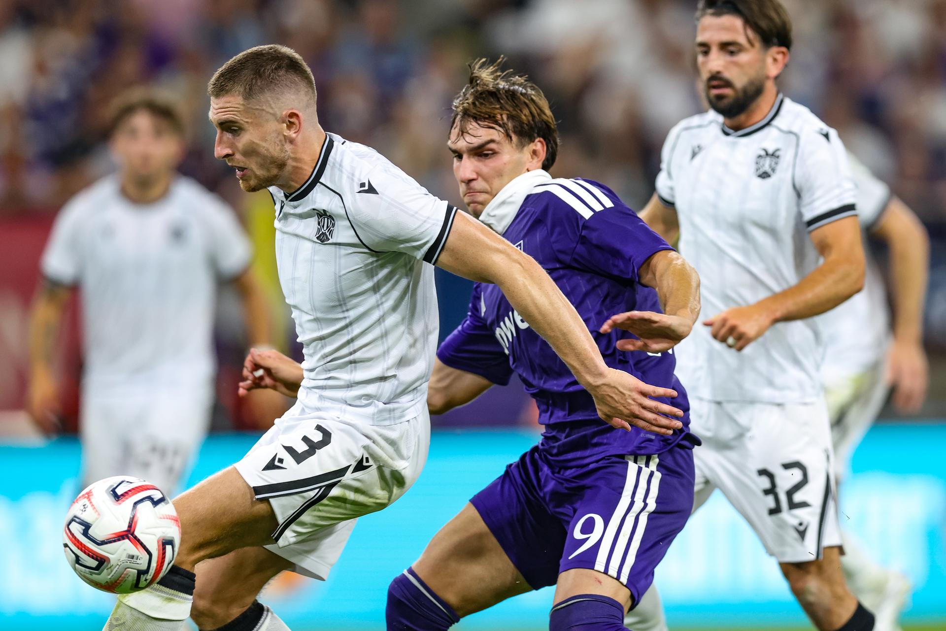 PAOK's Jonjoe Kenny and Anderlecht's Mihajlo Cvetkovic fight for the ball during a game between Belgian RSC Anderlecht and Greek club  PAOK , in Anderlecht, Brussels, Belgium, on Thursday 13 August 2026, a return leg game in the third qualifying round of the UEFA Europa League competition.  RSCA won 0-1 the first leg. BELGA PHOTO BRUNO FAHY