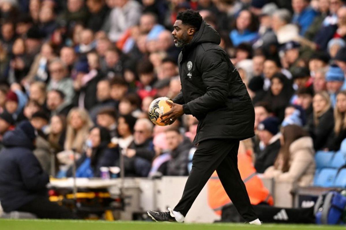 Manchester City's Ivorian assistant coach Kolo Touré holds the ball during the English FA Cup third round football match between Manchester City and Salford City at the Etihad Stadium in Manchester, north west England, on February 14, 2026.  Oli SCARFF / AFP