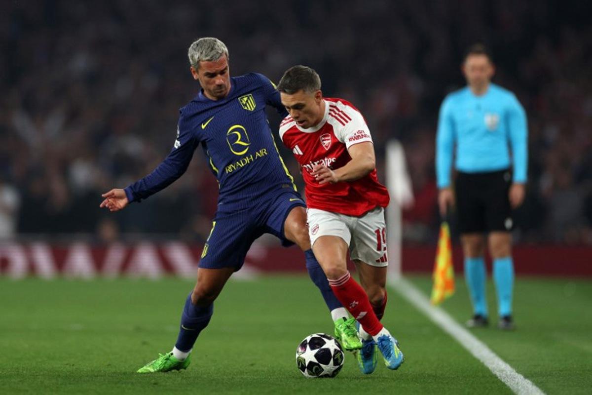 Atletico Madrid's French striker #07 Antoine Griezmann battles for the ball with Arsenal's Belgian midfielder #19 Leandro Trossard during the UEFA Champions League second-leg semi-final football match between Arsenal and Atletico Madrid at the Emirates Stadium in north London on May 5, 2026.  Adrian Dennis / AFP