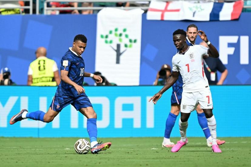 France's forward #10 Kylian Mbappe and England's forward #07 Bukayo Saka fight for the ball during the 2026 World Cup football tournament third-place match between France and England at the Miami Stadium in Miami on July 18, 2026.   CHANDAN KHANNA / AFP