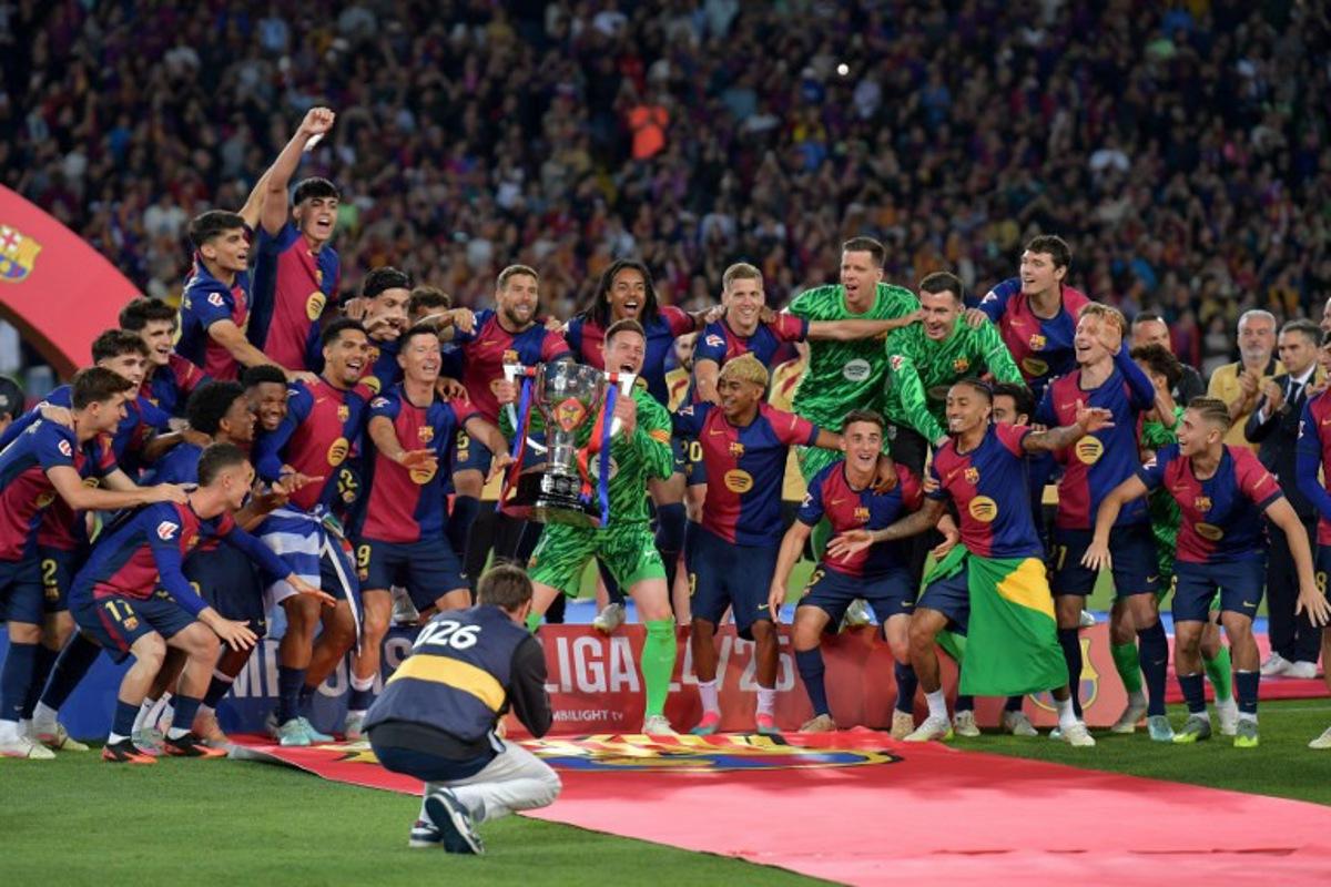 Barcelona's players celebrate their 28th Liga title after the Spanish league football match between FC Barcelona and Villarreal CF at Estadi Olimpic Lluis Companys in Barcelona on May 18, 2025.  MANAURE QUINTERO / AFP