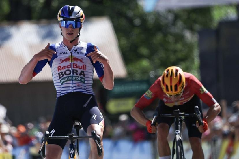 Red Bull - Bora - Hansgrohe's Belgian rider Maxim Van Gils celebrates as he cycles across the finish line to win ahead of Uno-X Mobility's Norwegian rider Tobias Johannessen (R) during the 6th stage of the Tour Auvergne-Rhone-Alpes cycling race (formerly known as the Criterium du Dauphine), 182,3km between Saint-Vulbas and Crest-Voland in the French Alps on June 12, 2026.  Anne-Christine POUJOULAT / AFP