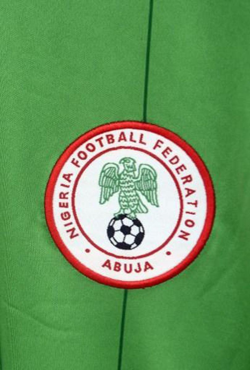 A logo f the Nigerian national football team is pictured on an official jersey for the 2014 World Cup on May 17, 2014 in Lagos.  AFP PHOTO/PIUS UTOMI EKPEI