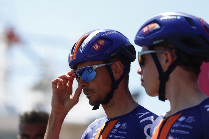 Team Picnic PostNL French rider Warren Barguil (L) looks on as he prepares to compete in the 12th stage of the Giro d'Italia 2026 - Tour of Italy cycling race between Imperia and Novi Ligure, Italy, on May 21, 2026.  Luca Bettini / AFP