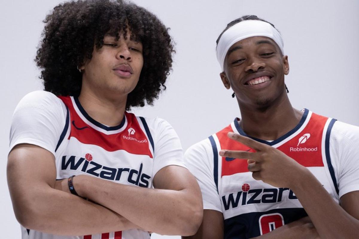 Bilal Coulibaly (R), French basketball player for the Washington Wizards, jokes around with Swiss teammate Kyshawn George at Wizards media day ahead of the NBA season at Capital One Arena in Washington, DC, September 30, 2024.  ROBERTO SCHMIDT / AFP