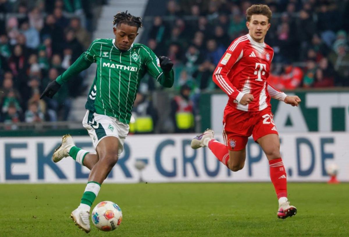 Bremen's Belgian midfielder #07 Samuel Mbangula (L) and Bayern Munich's German midfielder #20 Tom Bischof vie for the ball during the German first division Bundesliga football match between SV Werder Bremen and FC Bayern Munich in Bremen, northern Germany February 14, 2026.   Focke Strangmann / AFP