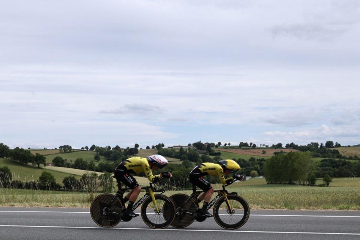 Team Visma | Lease a Bike's Belgian rider Wout Van Aert (L) cycles during the 3rd stage of the Tour Auvergne-Rhone-Alpes cycling race (formerly known as the Criterium du Dauphine), 28,4km team time trial departing and arriving in Perreux central France, on June 9, 2026.  Anne-Christine POUJOULAT / AFP