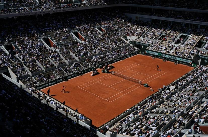 Spectators watch Italy's Jannik Sinner and Spain's Carlos Alcaraz play their men's singles semi final match on Court Philippe-Chatrier on day thirteen of the French Open tennis tournament at the Roland Garros Complex in Paris on June 7, 2024.  Dimitar DILKOFF / AFP