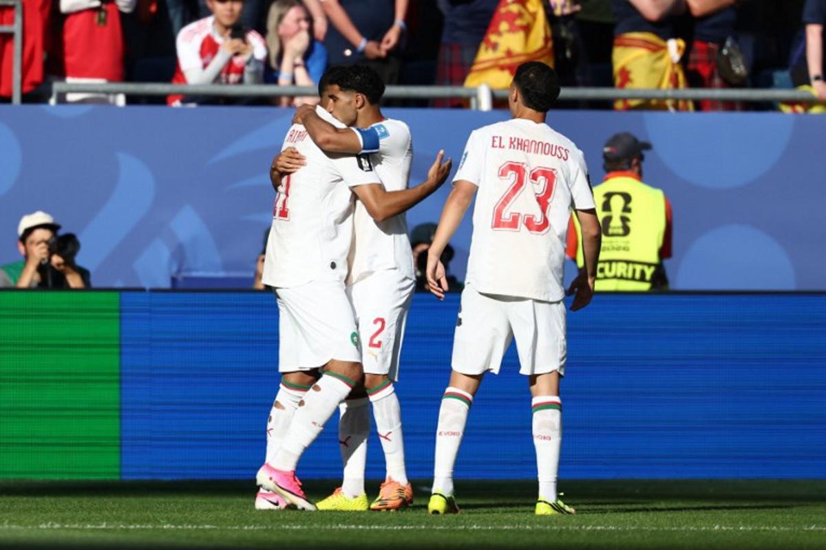 Morocco's midfielder #11 Ismael Saibari celebrates with teammates defender #02 Achraf Hakimi and midfielder #23 Bilal El Khannouss after scoring his team's first goal during the 2026 World Cup Group C football match between Scotland and Morocco at the Boston Stadium in Foxborough on June 19, 2026.   FRANCK FIFE / AFP