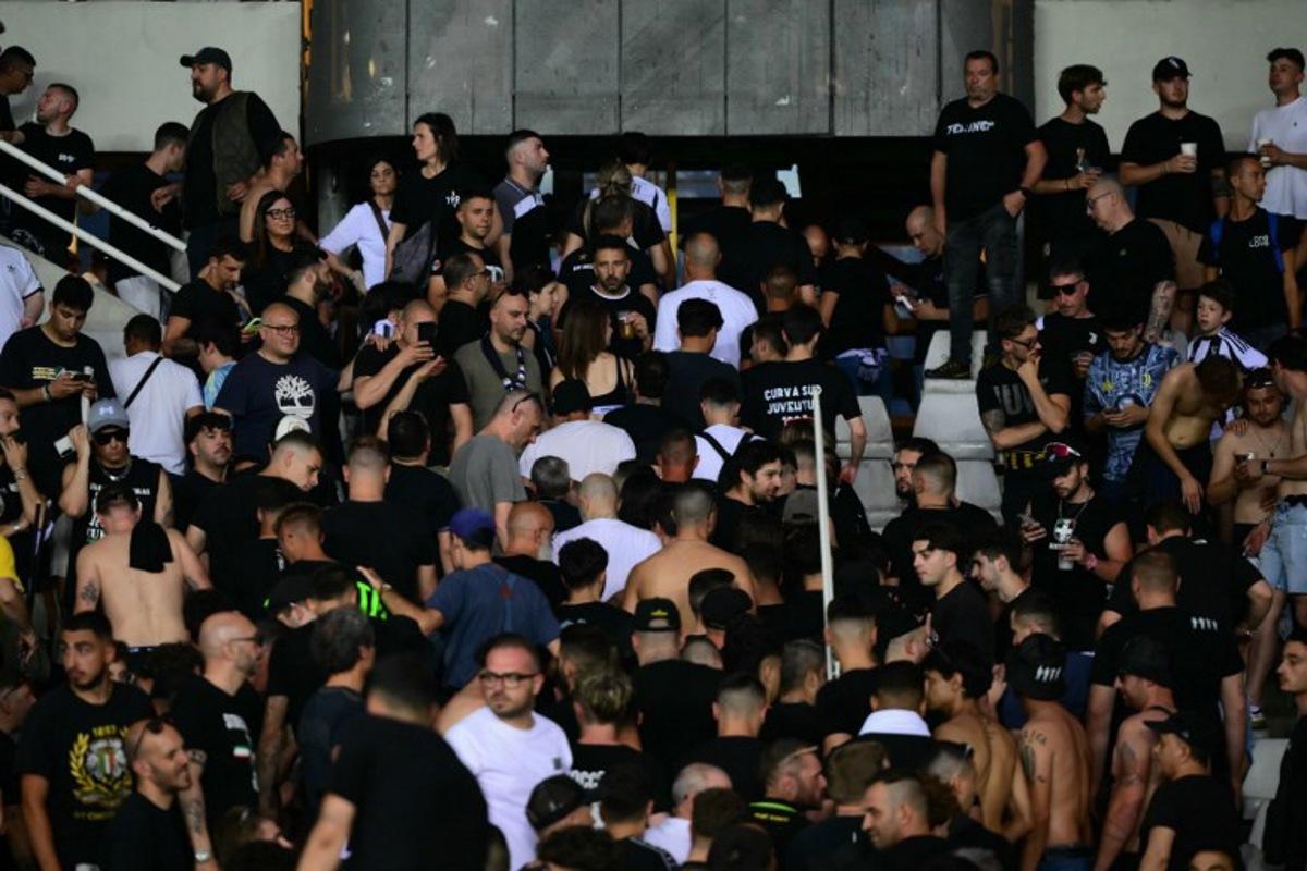 Juventus' supporters leave the stadium after a suspension of the Italian Serie A football match betweem Torino and Juventus FC at the Olympic Stadium Grande Torino in Turin on May 24, 2026.  MARCO BERTORELLO / AFP