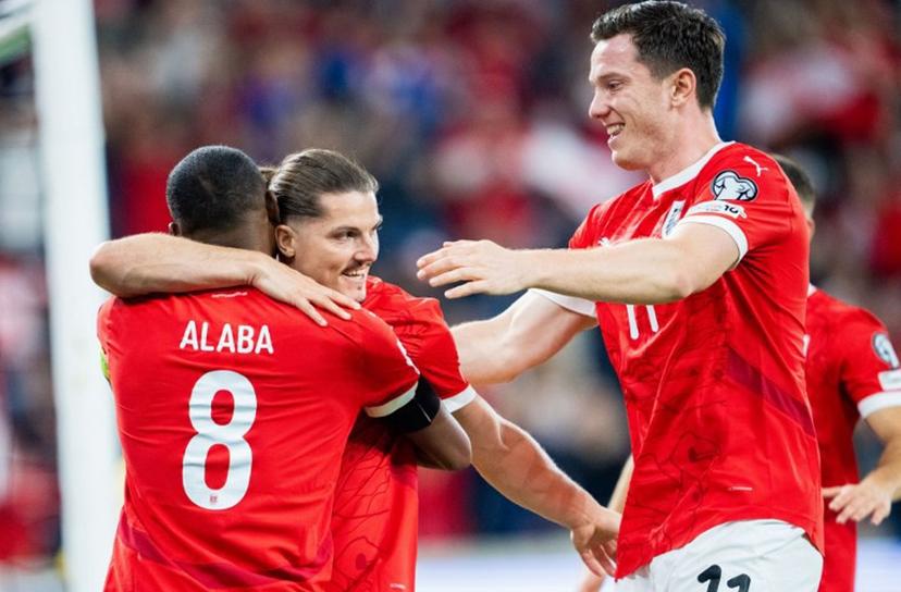 Austria's forward #09 Marcel Sabitzer (Back) celebrates his 1-0 from a penalty kick with Austria's defender #08 David Alaba (L) and Austria's forward #11 Michael Gregoritsch during the 2026 World Cup qualifiers Europe zone group H football match between Austria and Cyprus, on September 6, 2025 in Linz, Austria.  GEORG HOCHMUTH / APA / AFP