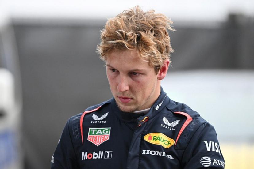 Red Bull Racing's New Zealand driver Liam Lawson walks back to his team garage after getting out of his car at the end of the Formula One Chinese Grand Prix in Shanghai on March 23, 2025.  GREG BAKER / AFP