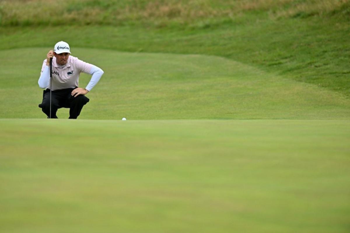 US golfer JT Poston lines up a putt on the 14th green on day three of the 151st British Open Golf Championship at Royal Liverpool Golf Course in Hoylake, north west England on July 22, 2023.                                                                                                                The 151st Open at The Royal Liverpool Golf Course is set to run until July 23. Glyn KIRK / AFP