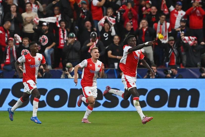 Slavia Prague's Senegalese defender #12 Youssoupha Mbodji (R) celebrates scoring his team's first goal with team mates during the UEFA Champions League football match between SK Slavia Prague and FK Bodoe/Glimt in Prague on September 17, 2025.  Michal Cizek / AFP