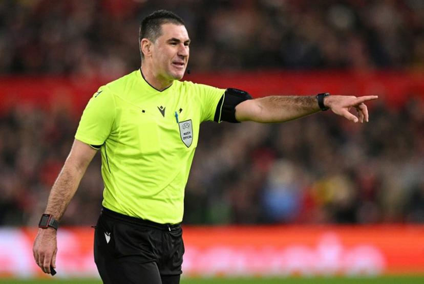 Slovenian referee Rade Obrenovic gestures during the UEFA Europa League round of 16, first leg football match between Nottingham Forest and FC Midtjylland at The City Ground in Nottingham, central England, on March 12, 2026.  Oli SCARFF / AFP