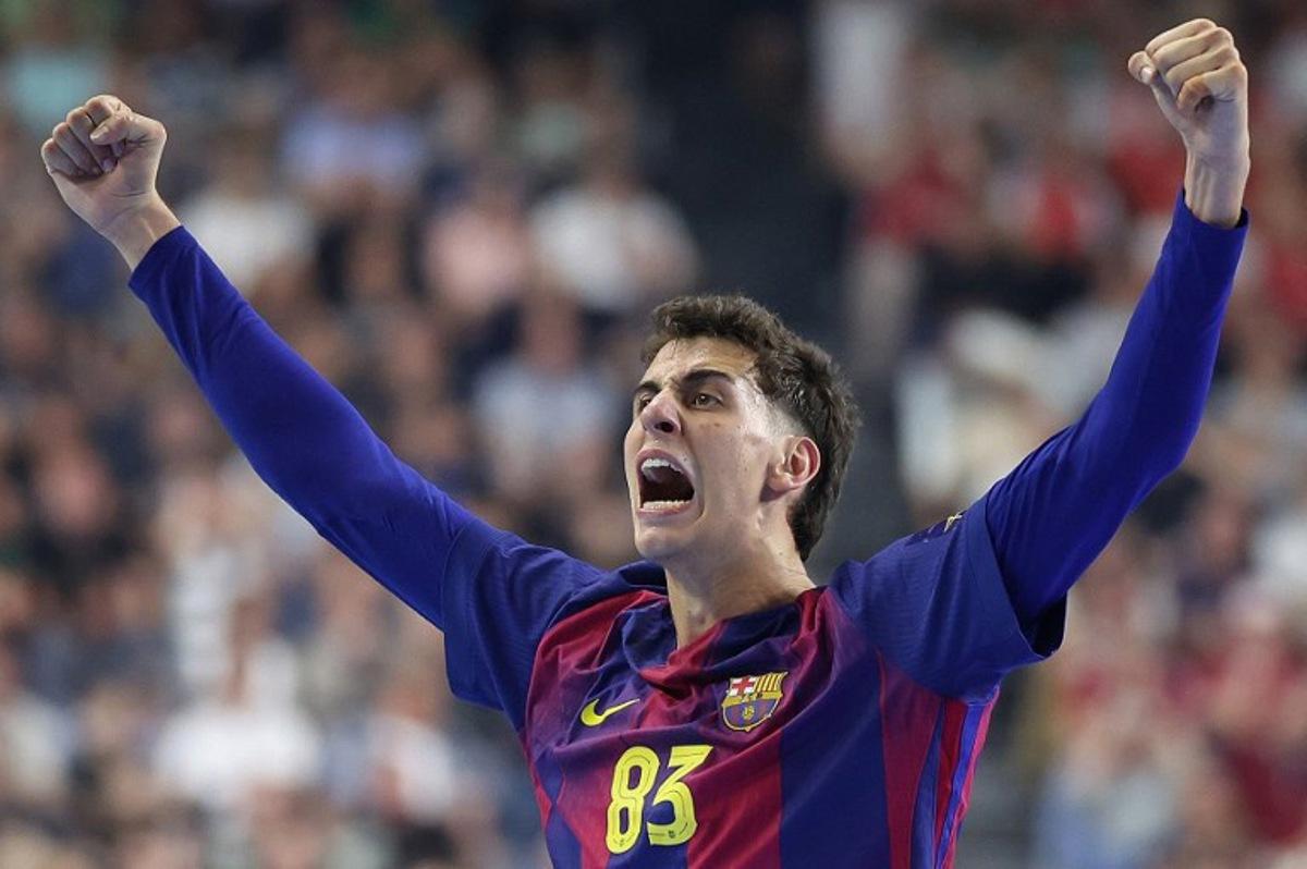 FC Barcelona's Spanish left wing #83 Ian Barrufet celebrates during the EHF Men's Handball Champions League Final 4 final between Barca and Fuechse Berlin in Cologne, western Germany on June 14, 2026.  Ronny HARTMANN / AFP
